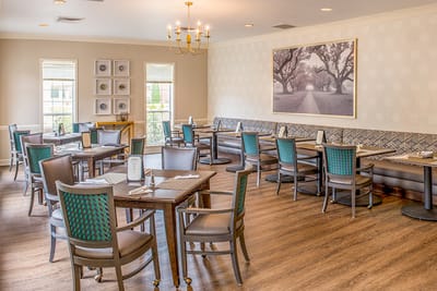Bright dining room with tables set for meals