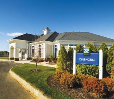 Exterior view of the clubhouse with lush landscaping