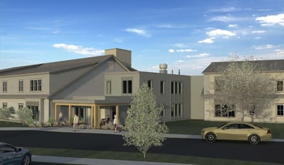 Exterior view of senior living community building with landscaping
