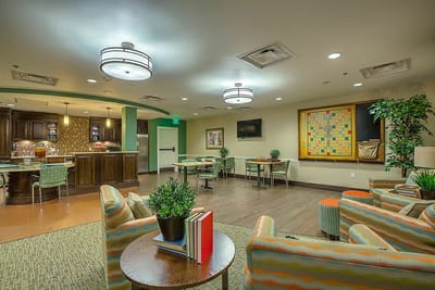 Bright common area with comfortable seating and games