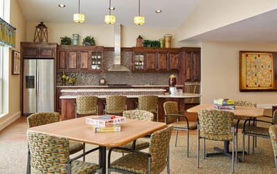 Bright common area with kitchen and dining tables