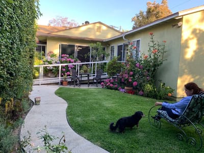 A resident enjoying the garden area with flowers