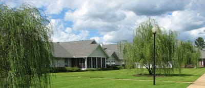 Exterior view of the facility with landscaping and trees