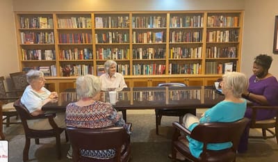 Residents engaging in a discussion in the activity room