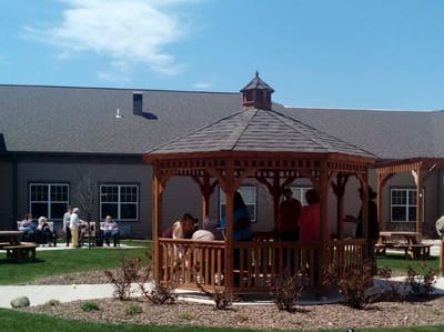 Residents enjoying time in a gazebo at an outdoor space