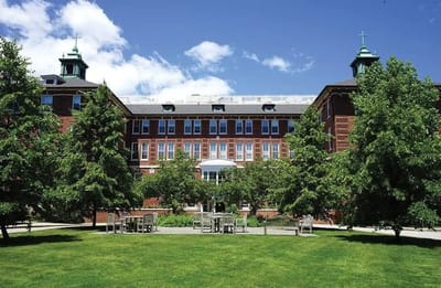 Exterior view of the Notre Dame du Lac building with greenery