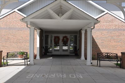 Entrance of Oak Park Village with benches and signage