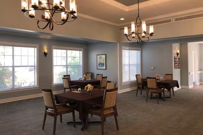 Bright dining room with tables set for meals
