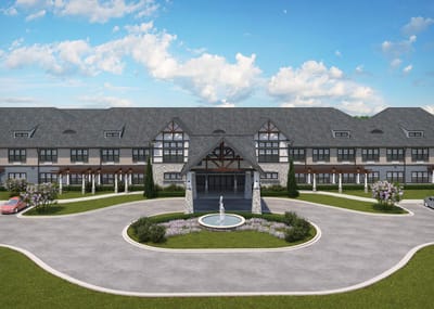 Exterior view of a senior living facility with fountain