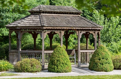 A gazebo in a landscaped garden area