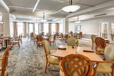 Bright dining area with wooden tables and chairs