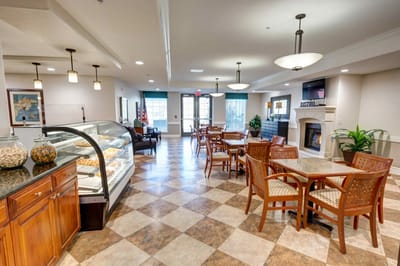 Bright dining area with tables and a dessert display