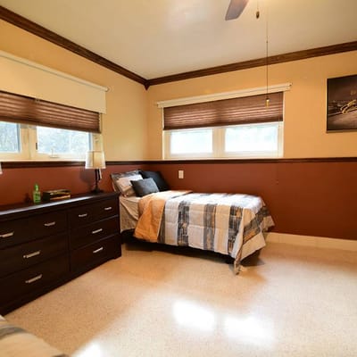 A cozy resident bedroom with two beds and furniture
