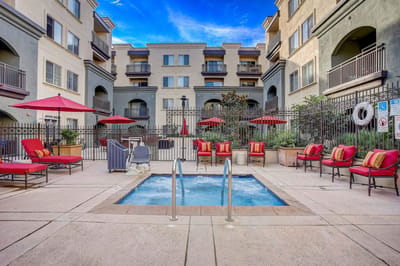 Outdoor pool area with lounge chairs and umbrellas