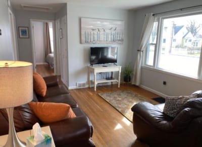 Living room with a couch, TV, and window