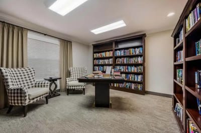 Cozy reading nook in a common area with bookshelves