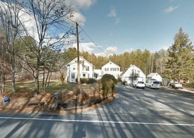 Exterior view of Pine View Haven facility with surrounding trees