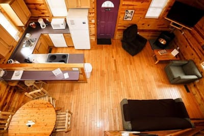 Cozy log cabin interior with kitchen and seating area