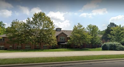 Exterior view of the nursing home surrounded by trees
