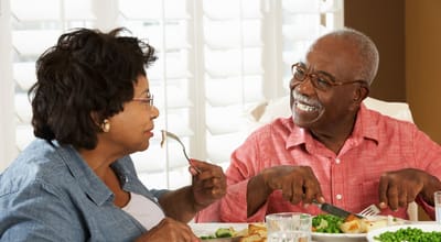 A couple enjoying a meal together at a dining table