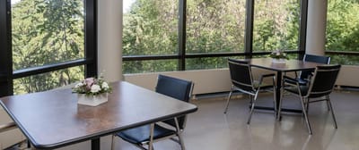 Bright common area with tables and outdoor view