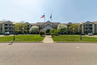 Exterior view of Rosehaven Manor with landscaped entrance