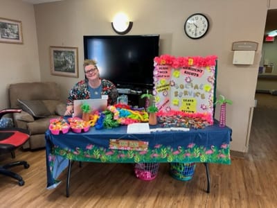 Staff member at a colorful event table with activities