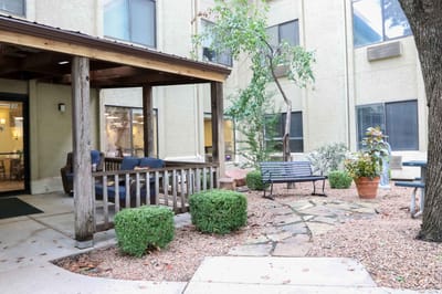 Outdoor patio area with benches and garden