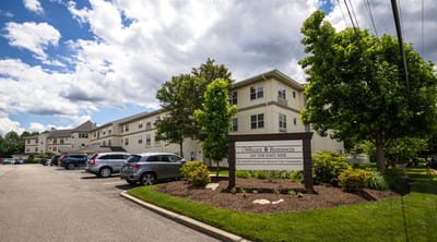 Exterior view of Wingate Residences building with parking