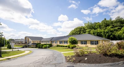 Facility building exterior with landscaped grounds