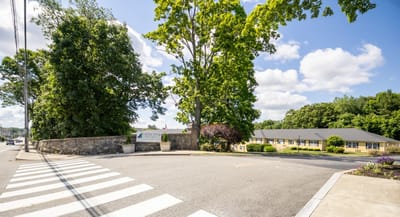 Entrance to Capitol Ridge at Providence with trees and building