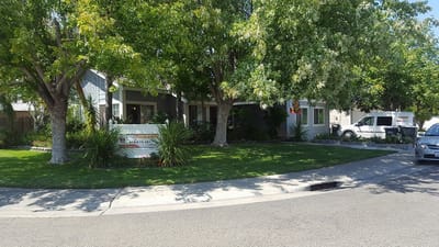 Exterior view of a senior care facility with greenery