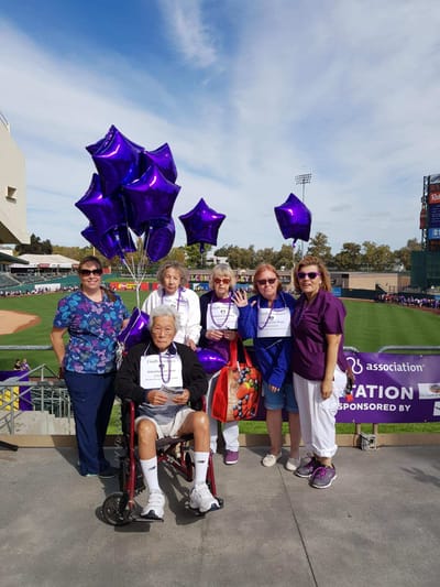 Residents and staff celebrating with balloons