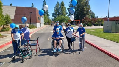 Residents enjoying an outdoor celebration with balloons