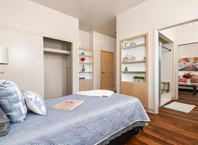 Well-furnished private resident room with a bed and decor