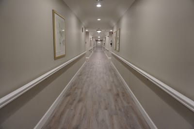 Well-lit hallway in a senior living facility