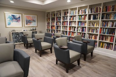 Cozy reading area with armchairs and bookshelves
