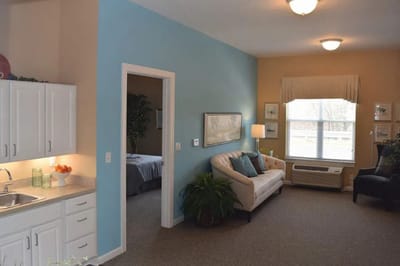 Bright interior room with a couch and kitchenette