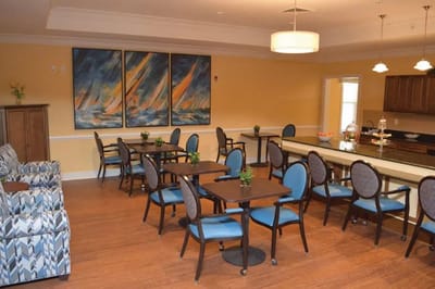 Dining room with tables and chairs in a bright setting