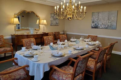 Elegant dining room setup with a chandelier and floral decor