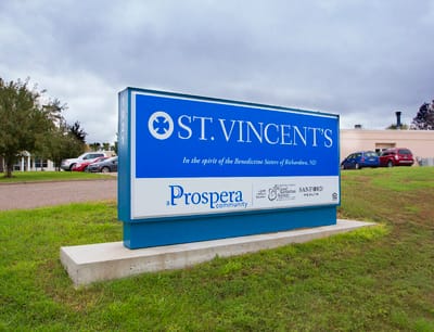 Exterior sign of St. Vincent's with a landscaped area
