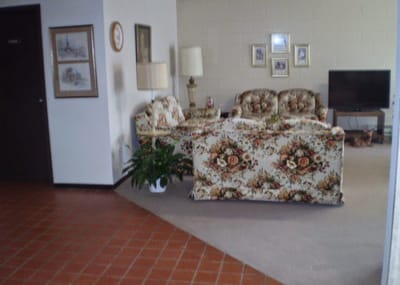 Seating area in a cozy common room with floral decor