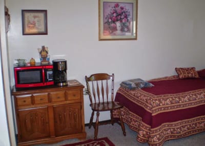 A cozy resident room with a bed and decor