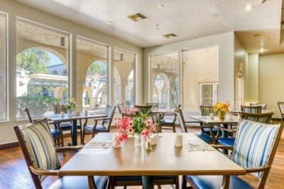 Bright dining area with tables and flowers