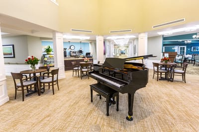 Interior common area featuring a grand piano and seating