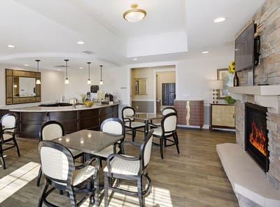 Bright common area with seating and a fireplace