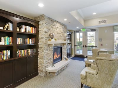 Cozy common area with fireplace and bookshelves