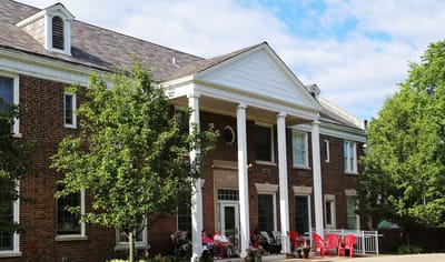 Exterior view of Sunnymere with residents relaxing