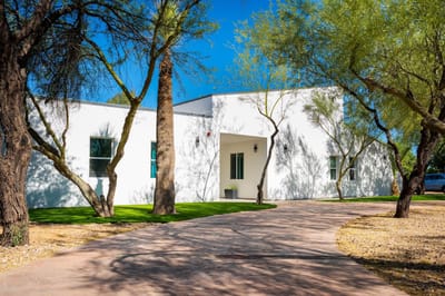 Entrance to Sunrise Care Homes with pathways and trees