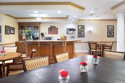Bright dining area with wooden furniture and flowers